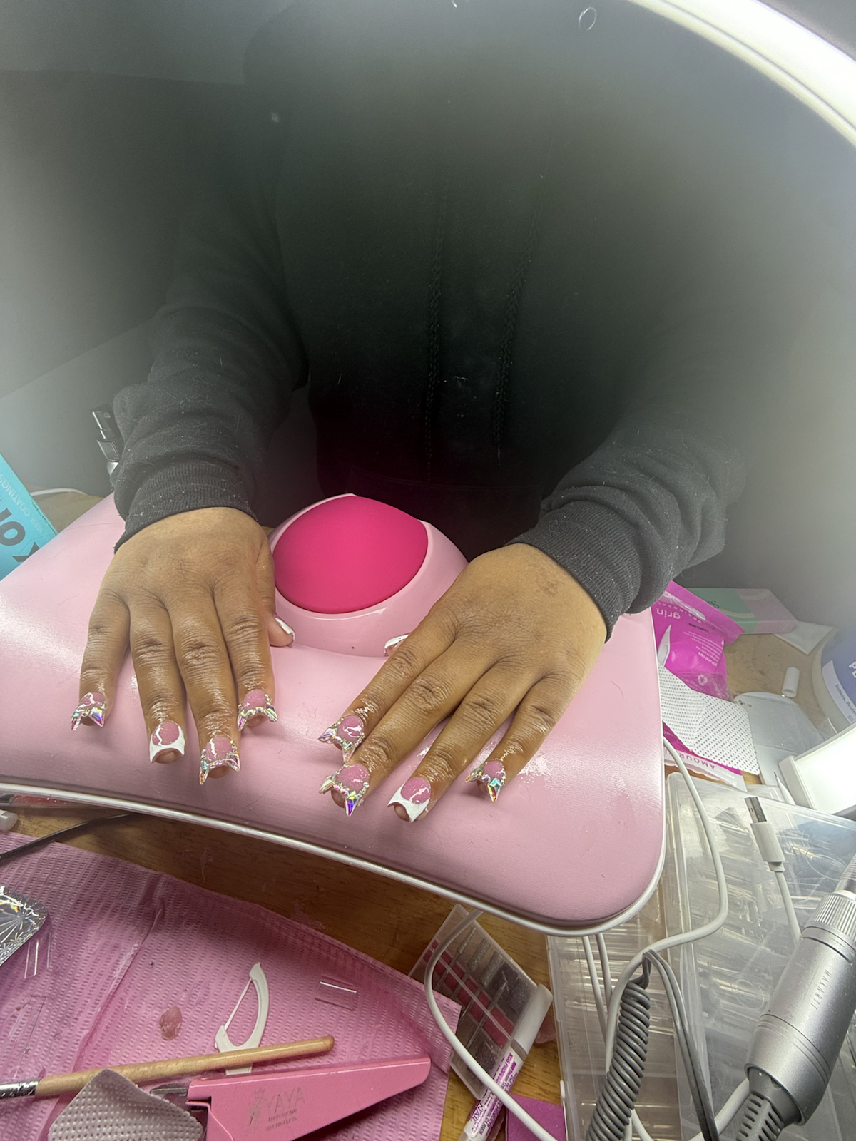 Pink nail set under salon light